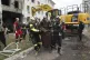 Rescue workers carry a dead body from a residential building damaged by a Russian attack on Kharkiv, Ukraine, Monday, Aug. 18, 2025