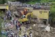 Local residents watch rescue workers search for victims in the rubble of damaged homes following Monday's flash flooding in Dalori village in Swabi, a district of Pakistan's Khyber Pakhtunkhwa province, August 19, 2025