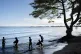 People wade into the waters of Lake Victoria, the world's second-largest freshwater lake, November 25, 2024, in Entebbe, Uganda