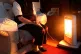An elderly lady sitting at home in Liverpool with her electric fire on