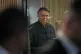 Former President Jair Bolsonaro smiles while leaving the Liberal Party headquarters in Brasilia, Brazil, July 23, 2025
