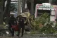 Police remove wreckage from the site of a bomb explosion outside an Air Force base in Cali, Colombia, August 21, 2025