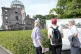Visitors speak with Kunihiko Iida, an atomic bomb survivor (Hibakusha) and volunteer tour guide for the iconic exhibition hall best known as the Atomic Bomb Dome in Hiroshima