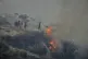 Residents try to extinguish a blaze in Omodos village, Cyprus, during a wildfire on the southern side of the east Mediterranean island nation's Troodos mountain range, July 24, 2025