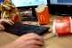 A McDonald's Big Mac box and fries carton are seen on an office workers desk, London