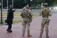 Armed members of the South Carolina National Guard talk with a man while positioned outside of Union Station in Washington, August 24, 2025