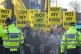 Demonstrators holding signs that read 