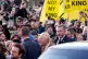 Charles ‘III’ Windsor walks past demonstrators holding signs that read ‘Not My King’, as he and his wife Camilla meet members of the public in Middlesbrough, February 13, 2025