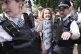 A woman is led away by police officers as supporters of Palestine Action take part in a mass action in Parliament Square, Westminster, central London, August 9, 2025