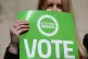 A Scottish Green Party supporter holding a placard