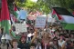 Demonstrators, from left, hold placards that read 'On the red carpet lets sow peace' and 'Free Palestine, peace has no borders' during a march in support of the Palestinian people in Gaza, during the Film Festival in Venice, Italy, August 30, 2025