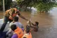 A rescue worker provides food to a villager at a flooded area in Maherian Wala, in Jhang district, Pakistan, September 1, 2025