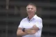 Photographed through a gate, Brazil's former President Jair Bolsonaro stands at the entrance of his home where he is under house arrest in Brasilia, Brazil, September 2, 2025