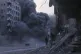 Palestinians take cover during an Israeli strike on a building in Gaza City, September 7, 2025