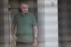 Brazil's former President Jair Bolsonaro stands at the entrance of his home where he is under house arrest in Brasilia, Brazil, September 11, 2025