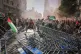 Protesters block the road in an attempt to disrupt the twenty-first stage of the Spanish cycling race La Vuelta, from Alalpardo to Madrid, Spain, Sunday, Sept. 14, 2025. (AP Photo/Manu Fernández) 