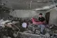 A boy carries a mattress from a destroyed apartment that was hit in an Israeli airstrike on Monday evening in Nabatiyeh town, south Lebanon, September 16, 2025