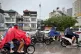 People drive through the rain in Hanoi, Vietnam, September 28, 2025, as Typhoon Bualoi brings strong winds, storm surges, and heavy rains