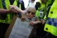 Police officers detain a protester as demonstrators take part in a Lift the Ban on Palestine Action protest organised by Defend our Juries in Parliament Square in London, September 6, 2025