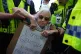 Police officers detain a protester as demonstrators take part in a Lift the Ban on Palestine Action protest organised by Defend our Juries in Parliament Square in London. Picture date: Saturday September 6, 2025