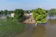 Villagers gather outside their homes, which are surrounding by floodwaters, in Tiba Gheal village, in Jhang district, Pakistan, September 2, 2025