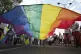 Participants hold up a rainbow flag during the Gay Pride march in Belgrade, Serbia, September 6, 2025