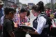 A relative of an unaccompanied minor deported from the United States reviews the list of those deported outside La Aurora International Airport, in Guatemala City, August 31, 2025