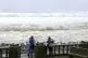 People watch as strong waves batter Basco, Batanes province, northern Philippines as Typhoon Ragasa affects the area, September 22, 2025
