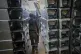 A worker carries part of a combat drone at Fire Point's secret factory in Ukraine on, August 14, 2025