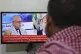 A man watches the news on TV, displaying footage of Ahmed al-Rahawi, the prime minister of the Houthi-controlled government, who was killed, along with others, in Thursday's Israeli strikes on the capital, in Sanaa, Yemen, August 30, 2025