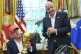 President Donald Trump holds the FIFA World Cup Winners Trophy as FIFA President Gianni Infantino looks on during an announcement in the Oval Office of the White House, August 22, 2025, in Washington