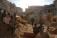 Palestinians watch machinery and some workers from Egypt searching for the bodies of hostages at Hamad City, in Khan Younis, southern Gaza Strip, October 26, 2025