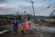 Residents walk in the aftermath of Hurricane Melissa in El Cobre, Cuba, Wednesday, Oct. 29, 2025