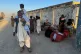 Local residents, who fled their homes following border clashes between Pakistan and Afghan forces, wait for transportation in Chaman, a town on the Pakistan side of the Afghanistan border, October 15, 2025