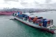 A container ship is seen near the terminal in Qingdao in eastern China's Shandong province on October 9, 2025