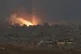 A fire erupts amid buildings destroyed during Israeli ground and air operations, following an Israeli military strike in the northern Gaza Strip, as seen from southern Israel, October 6, 2025