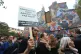 Demonstrators pass by a mural on Cable Street in the East End of London which commemorates the Battle of Cable Street, October 9, 2016