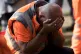 A bin worker putting his head in his hands at the Perry Barr Household Recycling Centre in Birmingham, September 1, 2017
