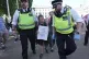 A woman is detained by police officers as supporters of Palestine Action take part in a mass action in Parliament Square, Westminster, central London, August 9, 2025