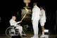 Charles Coste, left, passes the flame to Teddy Riner and Marie-Jose Perec in Paris, France, during the opening ceremony of the 2024 Summer Olympics, July 26, 2024