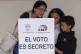 A voter casts her ballot with her children in a referendum on whether to allow foreign military bases in the country and rewrite the constitution through a constituent assembly, in Quito, Ecuador, November 16, 2025