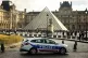 A police car parks in the courtyard of the Louvre museum, one week after the robbery, on October 26, 2025, in Paris