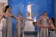 High Priestess Mary Mina (left) lights a torch from the Olympic flame during the flame lighting ceremony for the Milan Cortina 2026 Winter Olympics, at the archaeological museum of Olympia, Greece, November 26, 2025