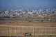 An Israeli army vehicle moves along the border of the Gaza strip, as seen from a southern Israel location on November 18, 2025