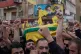 Hezbollah supporters shout slogans and raise their hands, as they carry the coffins of Hezbollah's chief of staff, Haytham Tabtabai, in the southern suburb of Beirut, Lebanon, November 24, 2025
