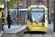 Commuters wait to board a tram in Manchester, May 2020