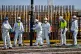 Workers wearing PPE while completing a concrete pour into the base of unit 2 nuclear reactor at Hinkley Point C nuclear power station near Bridgwater, Somerset, May 28, 2020