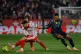 Girona's Ivan Martin (left) fights for the ball with Real Madrid's Kylian Mbappe during a Spanish La Liga soccer match between Girona and Real Madrid, in Girona, Spain, November 30, 2025