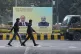 Men walk past a billboard with portraits of Indian Prime Minister Narendra Modi, right, and Russian President Vladimir Putin, hours before the scheduled arrival of the latter in New Delhi, India, December 4, 2025