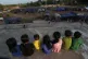 Children sit near tents in Srey Snam, Siem Reap province, after fleeing from their homes with their families at Cambodia's border with Thailand, December 9, 2025